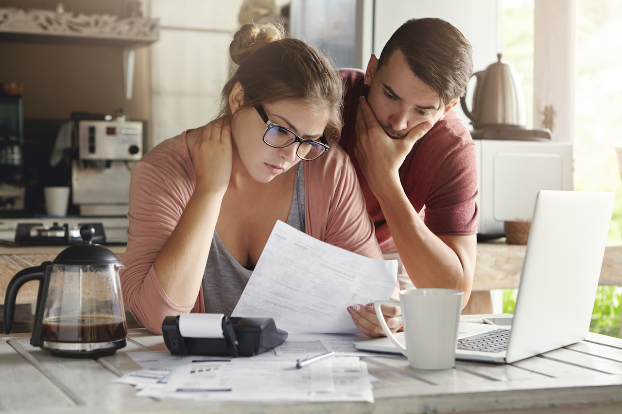 A young couple calculating their expenses